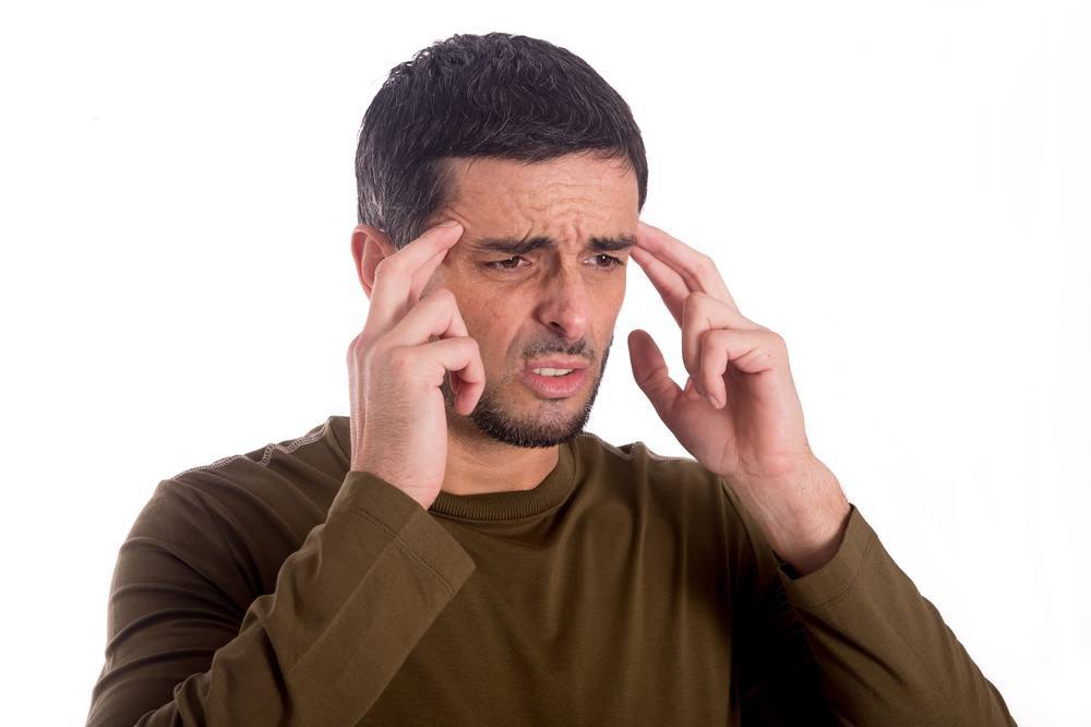 man worried with a headache